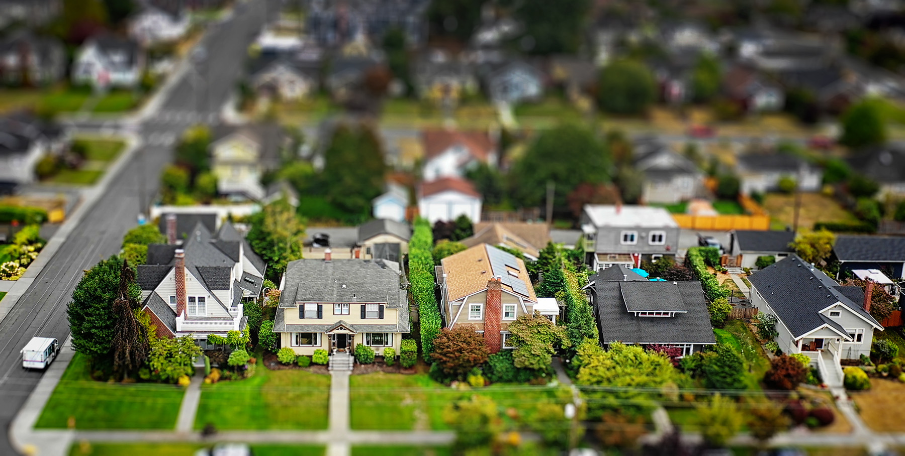 tilt shift shot of suburban neighborhood model with different kinds of houses